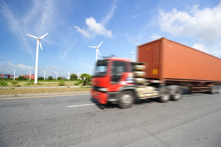 Generic big trucks speeding on the highway at sunset - Transport industry concept , big truck containersの写真素材