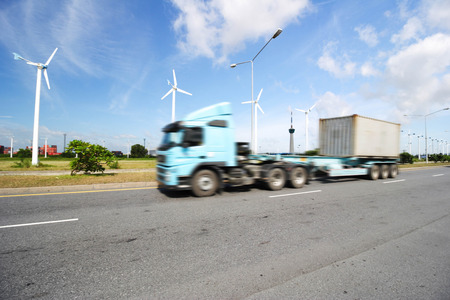 Generic big trucks speeding on the highway at sunset - Transport industry concept , big truck containersの写真素材