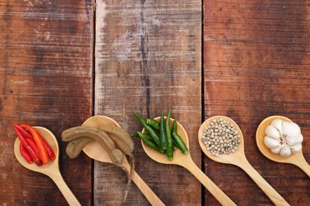 Spices and herbs in  wooden spoons.の写真素材