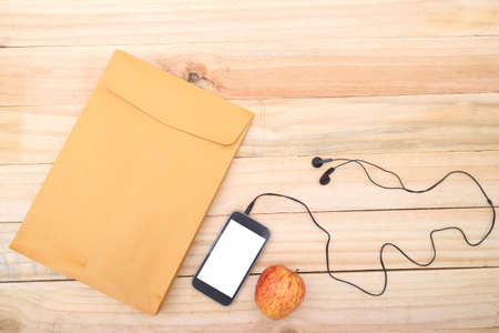 Outfit of traveler, student, teenager, young woman or guy. Overhead of essentials for modern young person. Different objects on wooden background.の写真素材