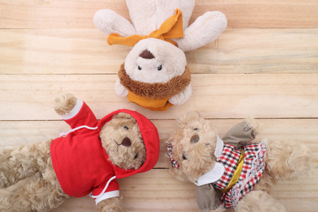 three Cute teddy bear on wood backgroundの写真素材