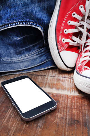 Outfit of traveler, student, teenager, young woman or guy. Overhead of essentials for modern young person. Different objects on wooden background.の写真素材