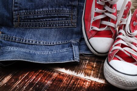 Outfit of traveler, student, teenager, young woman or guy. Overhead of essentials for modern young person. Different objects on wooden background.の写真素材