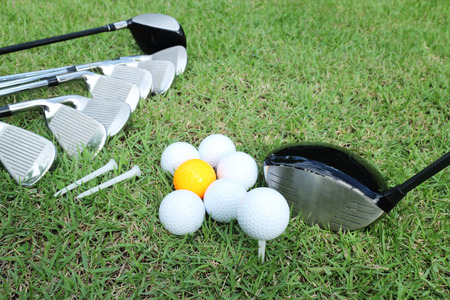 Golf ball and golf club in bag on green grassの写真素材