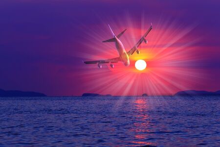 Airplane in the sky at sunsetの写真素材