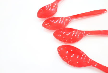 four children's spoons laid out like a fan on a white backgroundの写真素材