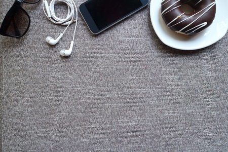 Modern working place on grey wood table. From above view on the well equipped working place blank...