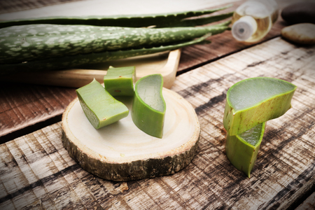 aloe vera with aloe vera gel on wooden table. top viewの写真素材