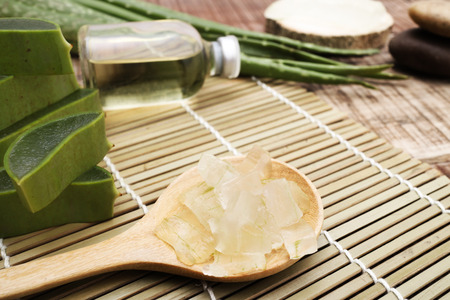 aloe vera with aloe vera gel on wooden table. top viewの写真素材