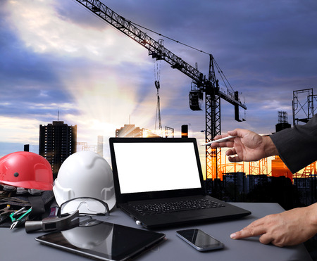 Industry 4.0 and Smart manufacturing concept. Laptop computer with Industrial 4.0 process diagram on screen against the industrial infrastructure background.の写真素材