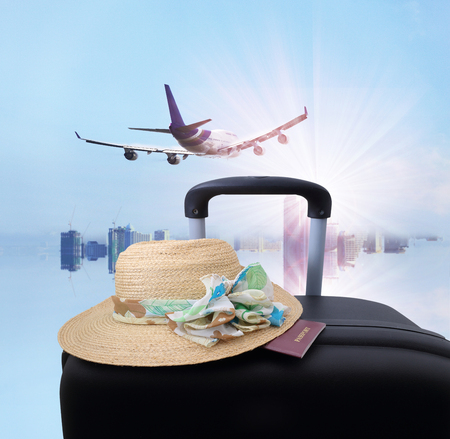 stack of traveling luggage in airport terminal and passenger plane flying over sky and city backgroundの写真素材