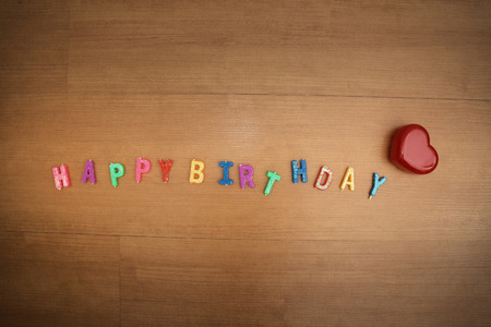 Happy Birthday,Daisy flowers with a tag Happy Birthday on wooden backgroundの写真素材