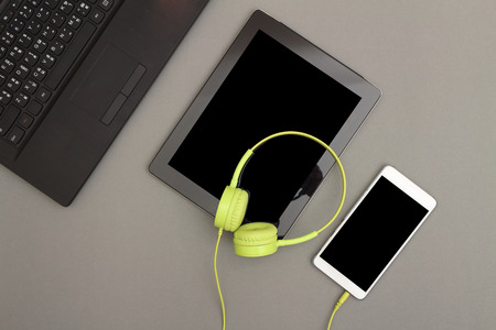 Office  table with computer, head phone, cell-phone and computer note book ,  Top view with copy spaceの写真素材