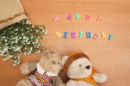 Happy Birthday,Daisy flowers with a tag Happy Birthday on wooden backgroundの写真素材