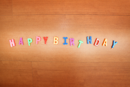 Happy Birthday,Daisy flowers with a tag Happy Birthday on wooden backgroundの写真素材