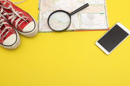Preparation for travel, cellphone,  road map, on floor 