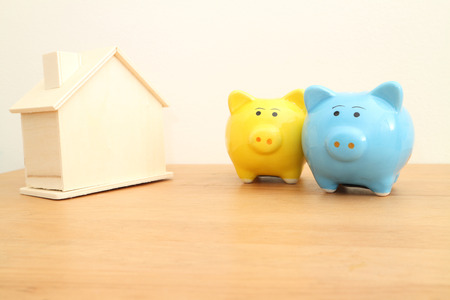 yellow and blue piggy bank on wooden table , saving,money concept.の写真素材