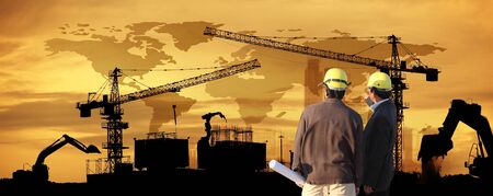 site manager and project manager on site,two civil engineer working in building construction site...