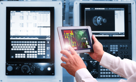 Engineer hand using tablet with machine real time monitoring system software.digital manufacturing...