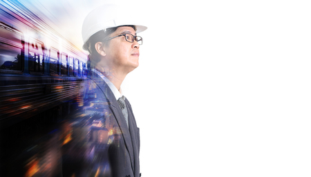 Businessman walking along a deserted railway station platform and getting ready to board a waiting passenger train. Transportation travel conceptの写真素材