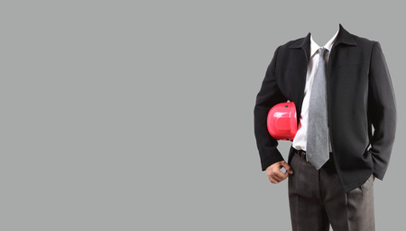 Handsome young man in shirt  standing against grey backgroundの写真素材
