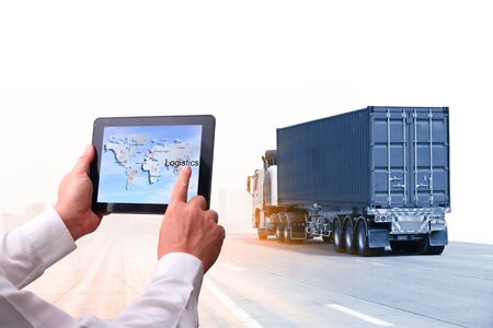 Truck run on road, Drive on road, transportation logistics concept,Businessman hold tablet or mobile phone working control logistics or import export industryの写真素材