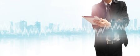 Businessman using tablet analyzing sales data and economic growth graph chart. Business strategy. の写真素材