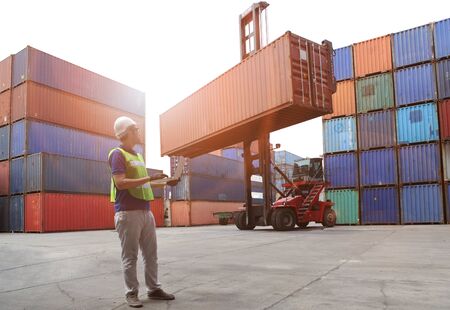 Engineering working and he is loading container for support logistics and import export businessの写真素材