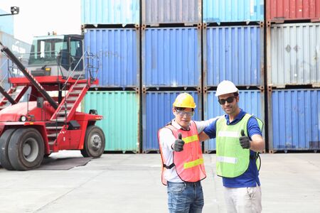 Engineering group working and they are loading container for support logistics and import export businessの写真素材
