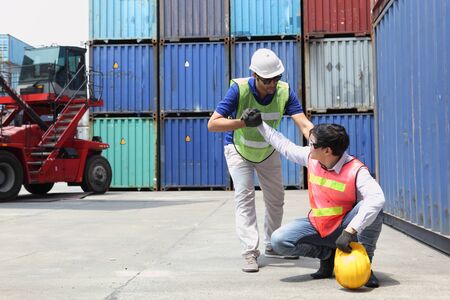 Construction worker or Industrial Engineers has an accident while working on Container ship in import and export business logistic company. Industry and Transportation concept.の写真素材