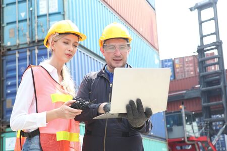 businessman or Foreman control loading Containers box from Cargo and inspector checking Containers...