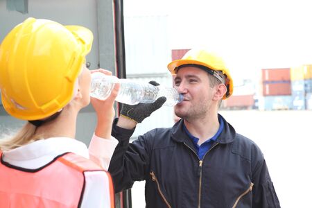 engineering  team on site working area , they are  drinking  water after work. の写真素材