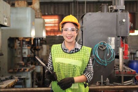  Female Industrial Engineers with  machine. Assist production engineer in industry. He checking or...