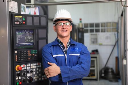 Male  Industrial Engineers in Hard Hats  with  machine. Assist production engineer in industry. He checking or push metalwork control in industrial In a plastic factory for car. Concept Successful Of Work.の写真素材