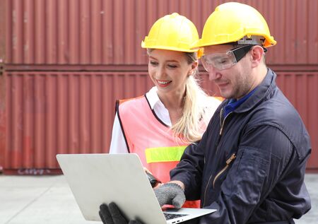 Engineering group working and they are loading container for support logistics and import export businessの写真素材