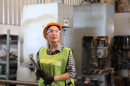  Female Industrial Engineers with  machine. Assist production engineer in industry. He checking or push metalwork control in industrial In a plastic factory for car. Concept Successful Of Work.の写真素材