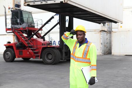 Close up of An African American handsome black engineer he is working in container box yard areaの写真素材