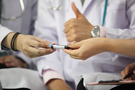 Doctor holding sample covid-19 vaccine vial with medication, closeup.の写真素材