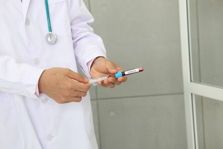 Doctor holding sample covid-19 vaccine vial with medication, closeup.