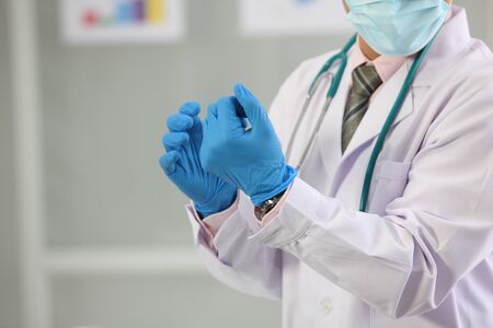  doctor wearing protective gloves, hands close upの写真素材