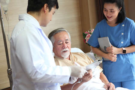 Happy senior patient and doctor at hospital , while spending time togetherの写真素材