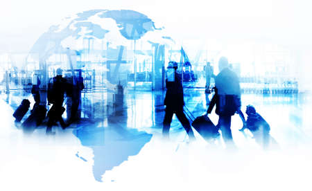 Silhouettes of business people walking  against a modern cityscape or airport . Toned image double...