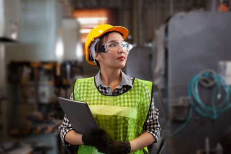 Female Industrial Engineers with  machine. Assist production engineer in industry.の写真素材