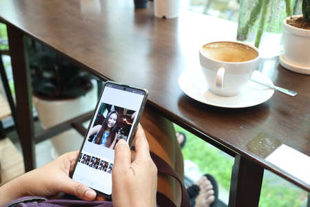 new normal lifestyle , woman using mobile phone for talking with her friendの写真素材