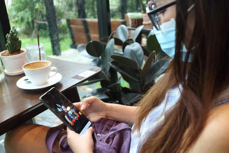 new normal lifestyle , woman using mobile phone for talking with her friendの写真素材