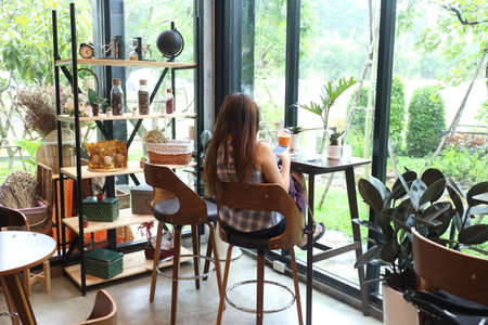 new normal lifestyle , woman using mobile phone for talking with her friendの写真素材