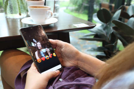 new normal lifestyle , woman using mobile phone for talking with her friend