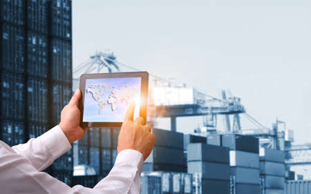 Double exposure of hand man with world map for logistic network distribution on background and Logistics Industrial Container Cargo freight ship for shipping and Transportation, import-exportの写真素材