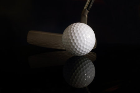 Golf ball and golf clubs on dark Backgroundの写真素材