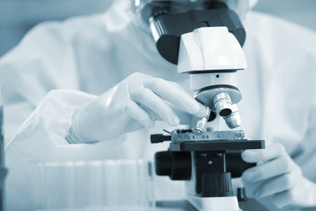Laboratory research. Team work Scientists  study data and evaluating microscope success. they are doing research with dropper chemical testing life science and find vaccine for covid 19の写真素材